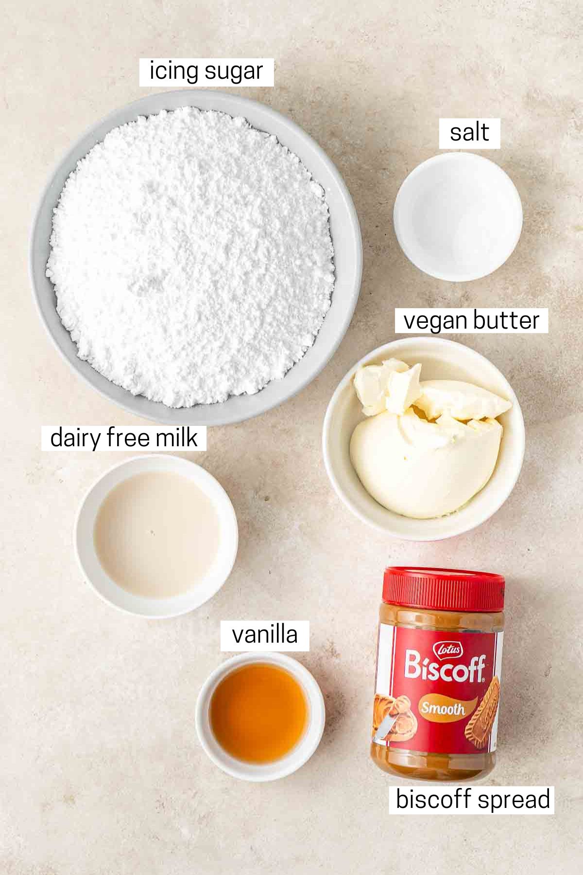 All ingredients needed for vegan biscoff buttercream laid out in small bowls.