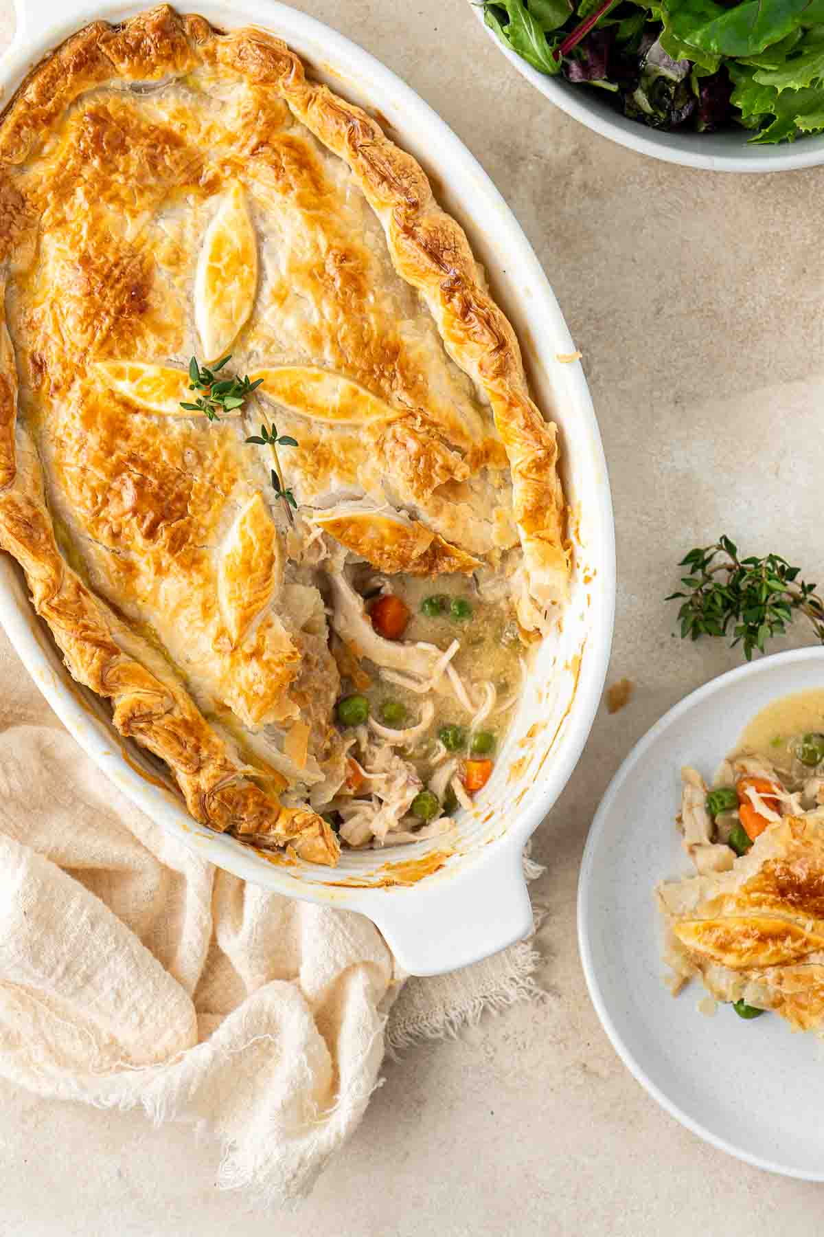 Chicken pot pie with a serving taken and put on a plate.