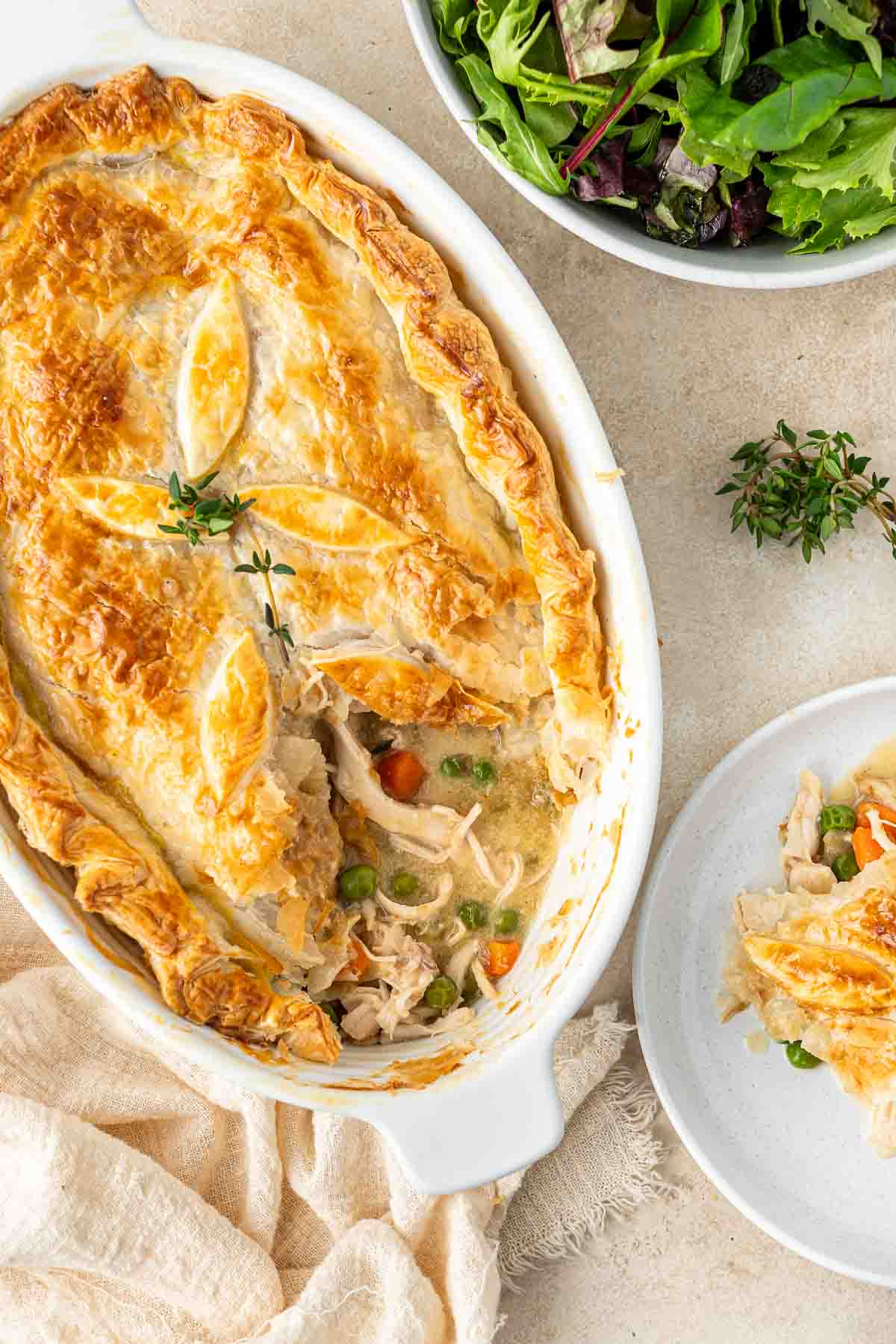 Dairy free chicken pot pie with a serve taken and placed on a plate. 