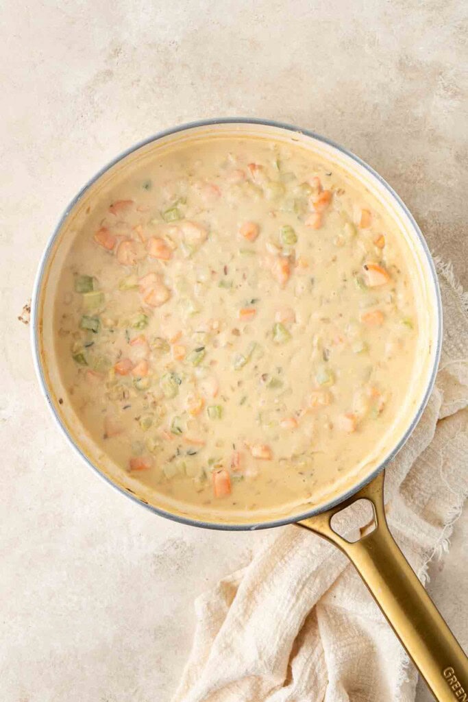 The creamy pie filling sauce in a frying pan.