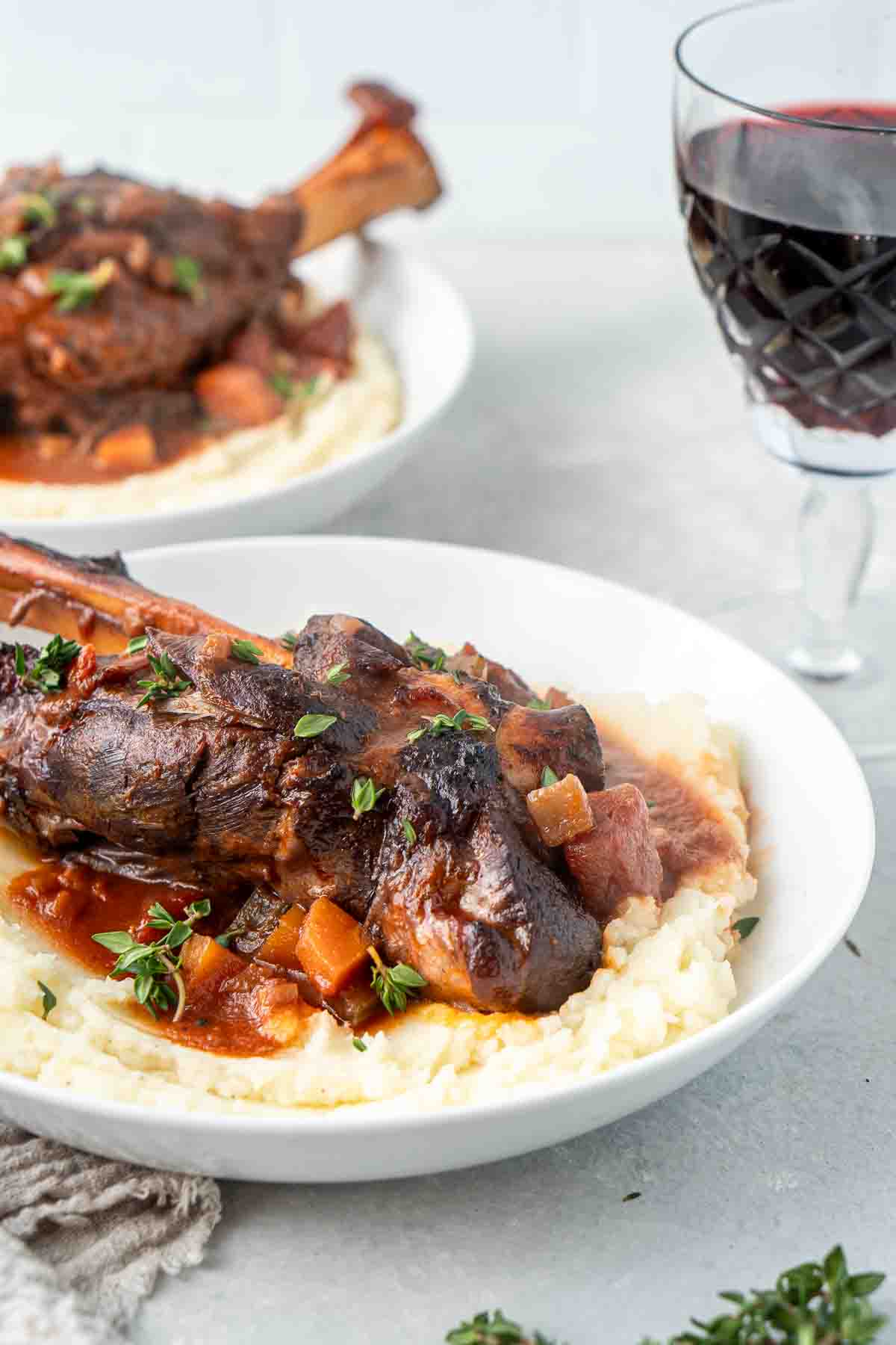 Lamb shanks on a bed of mashed potato.