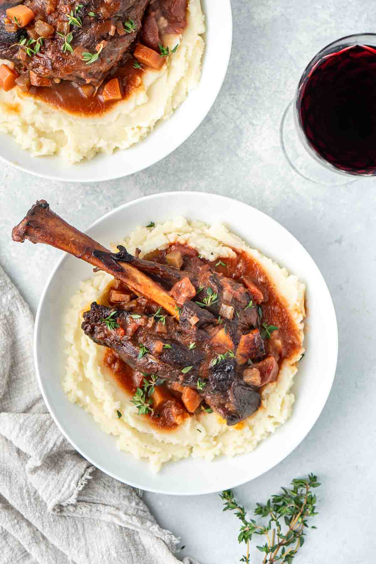 Red wine braised lamb shank served on a bed of mashed potato.