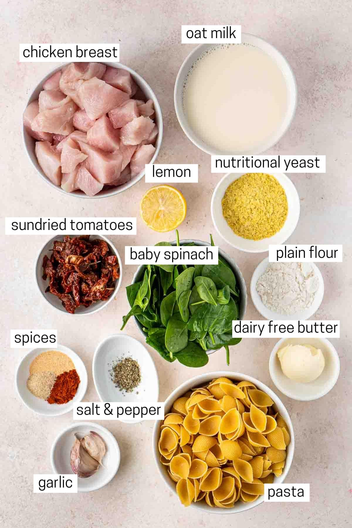 All ingredients needed to make marry me chicken pasta laid out in bowls.