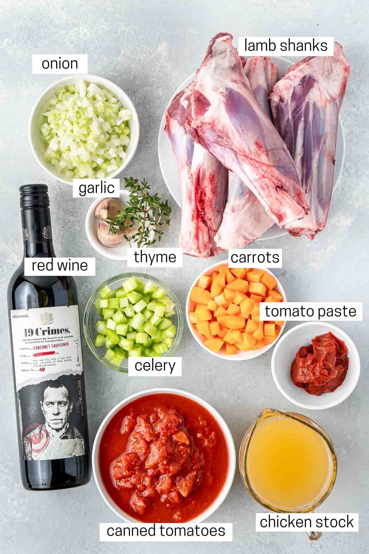 All ingredients needed to make braised red wine lamb shanks laid out in bowls.