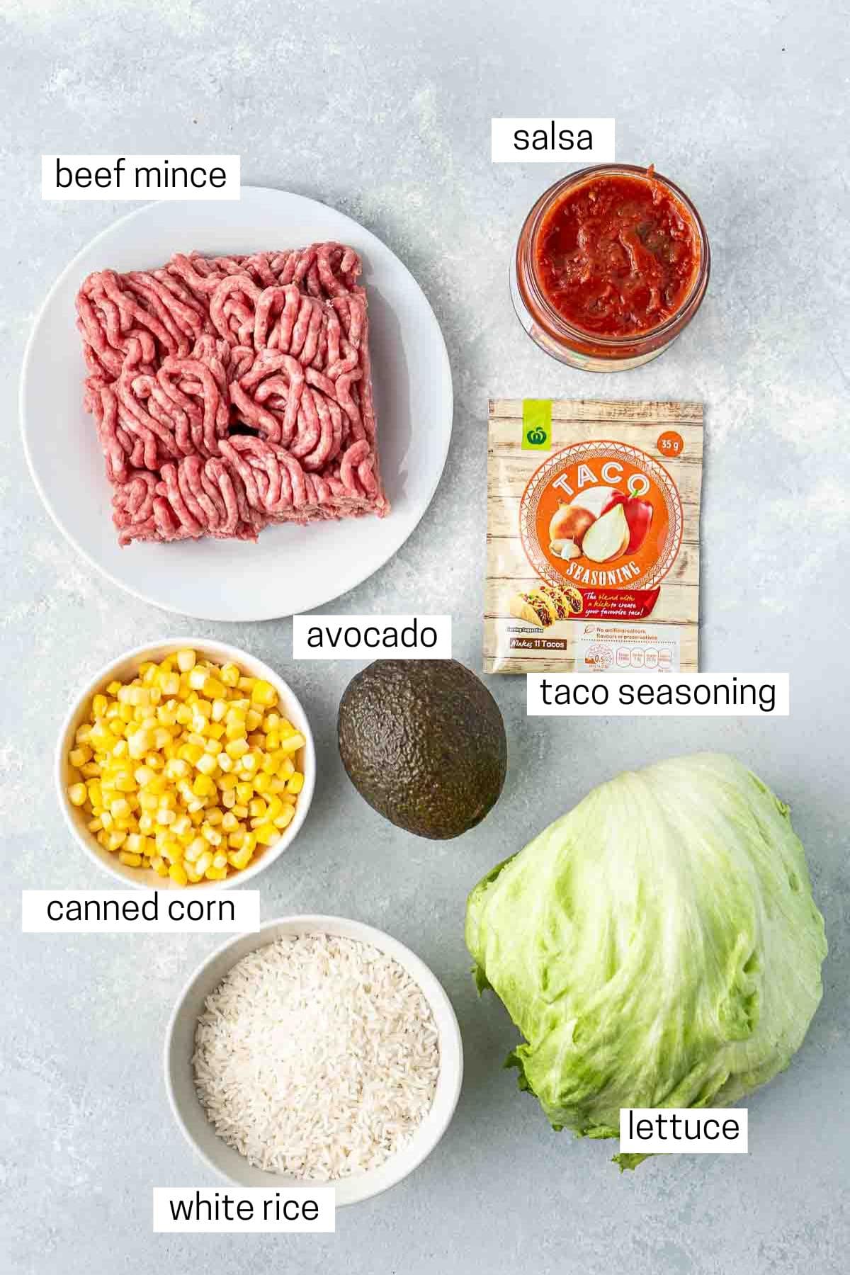 All ingredients needed for taco bowls laid out in bowls.