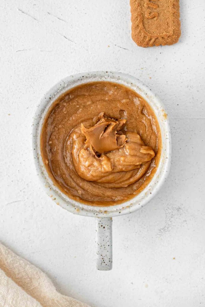 Adding the spoon of biscoff spread to the batter.