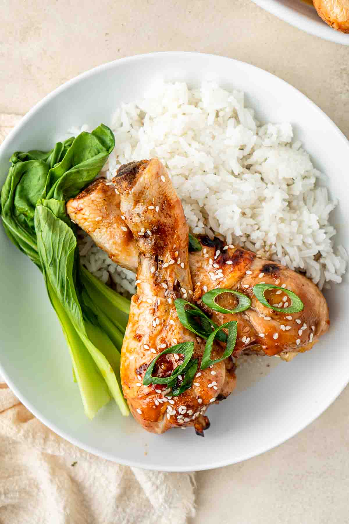 Chicken drumsticks over rice.