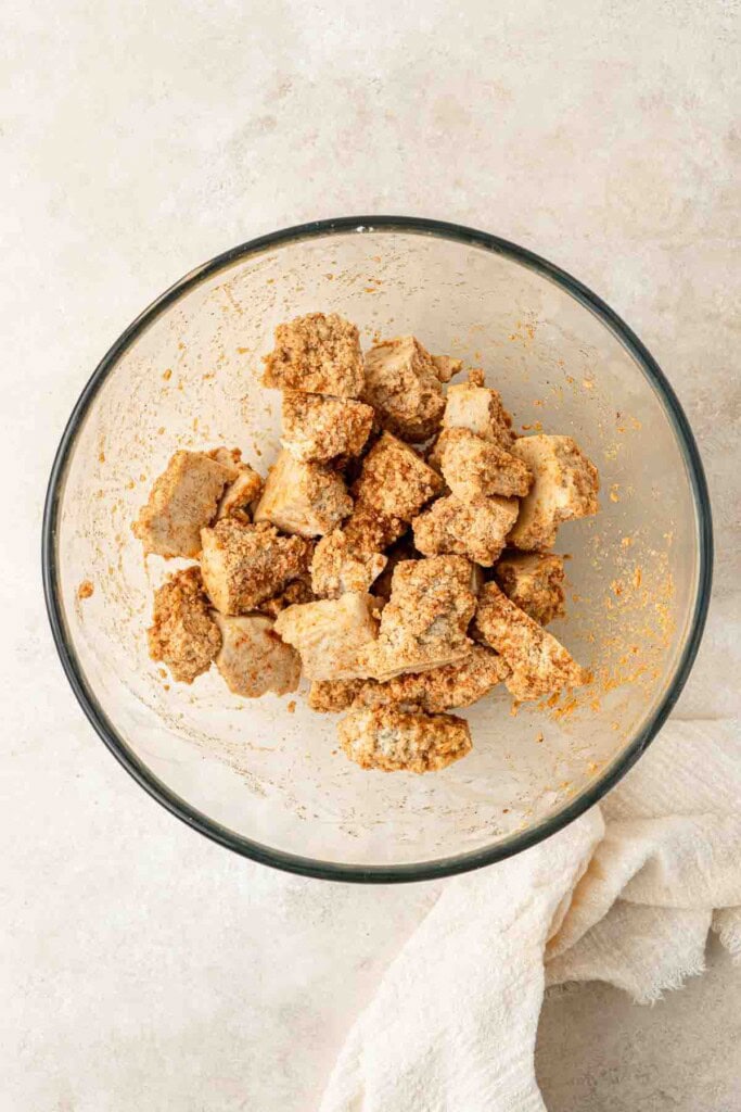 Tofu pieces in a glass mixing bowl.