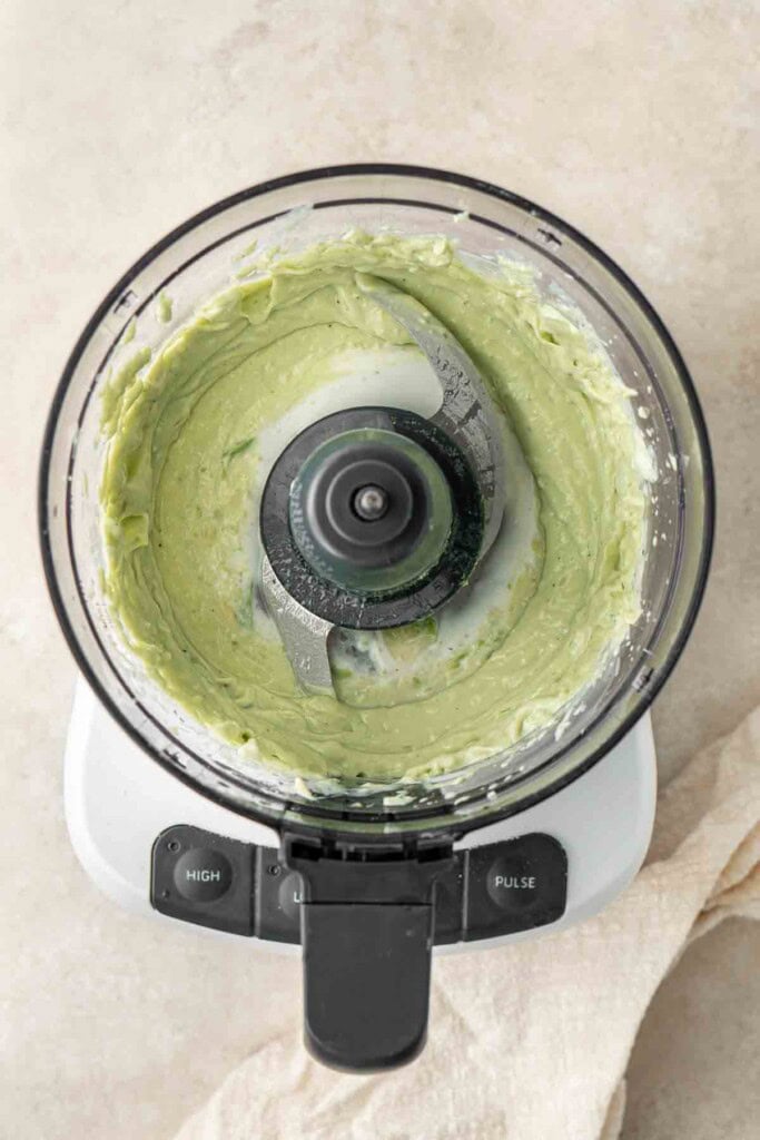 The green avocado yoghurt dressing in the food processor.