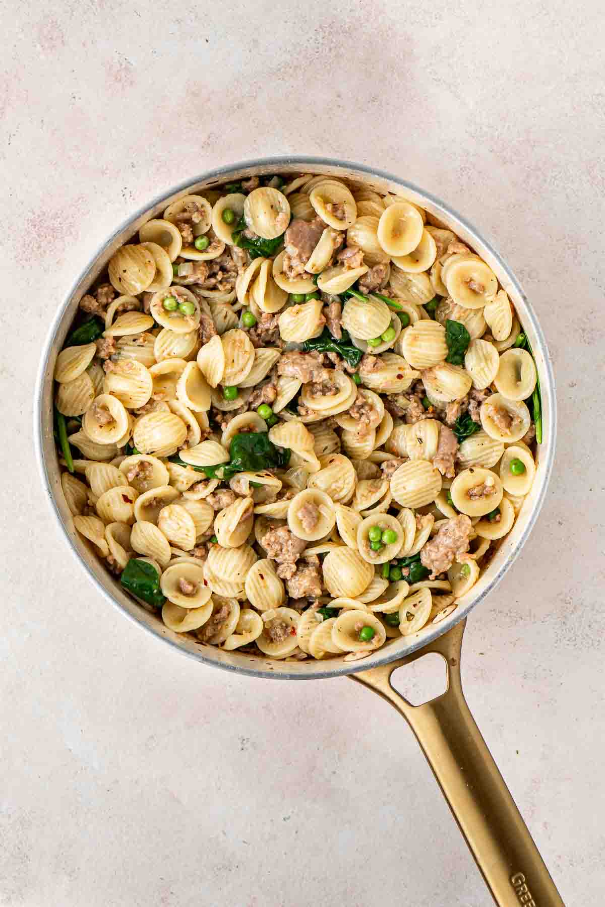 Sausage and spinach orecchiette i the pan.