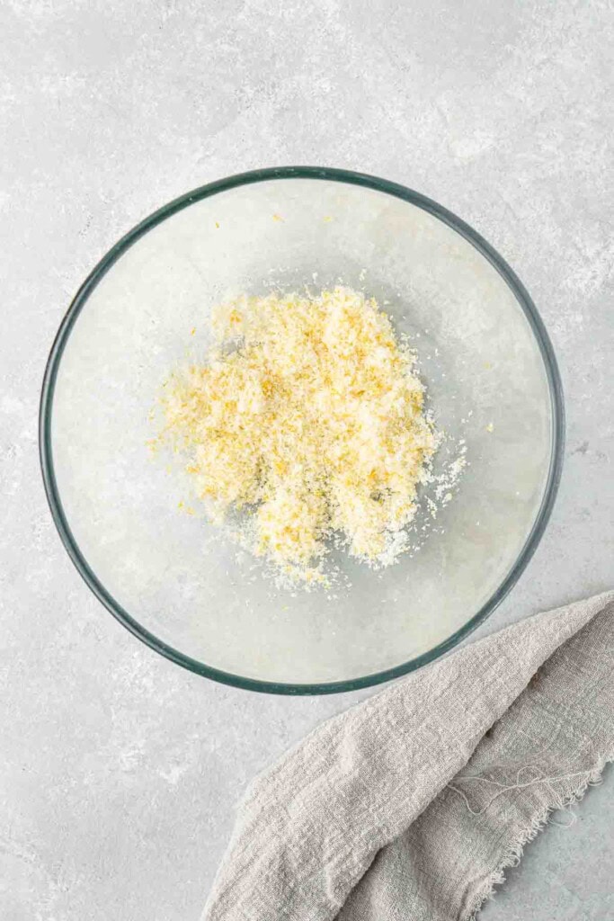 Lemon zest and white sugar in a mixing bowl.