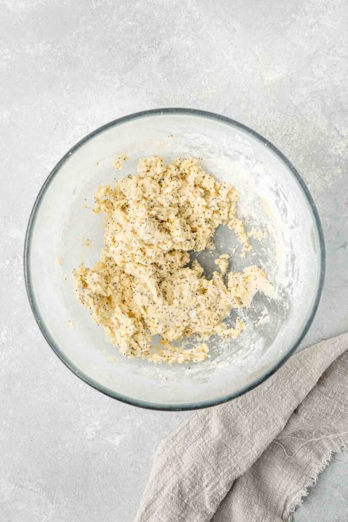 Soft cookie dough in a glass mixing bowl.