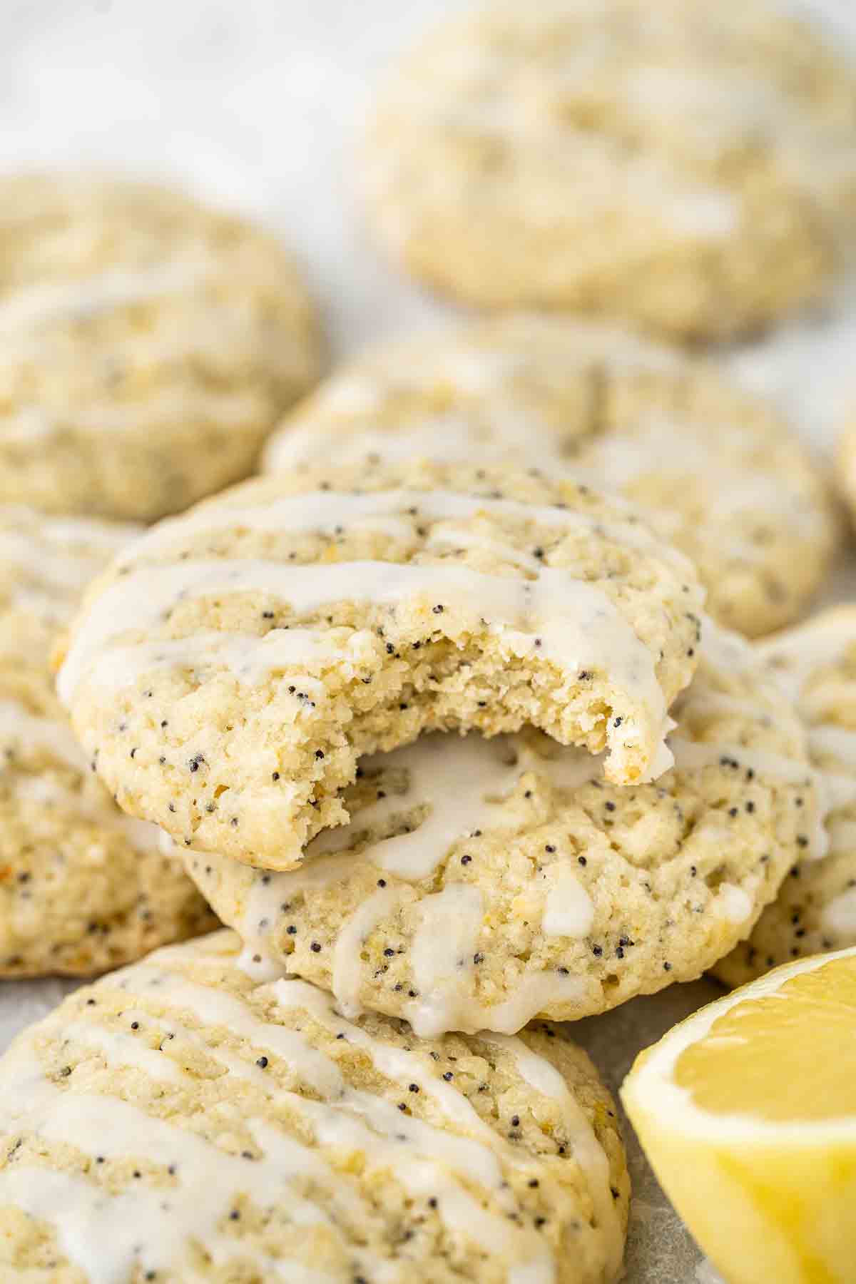 Lemon poppy seed cookies with a bite taken.