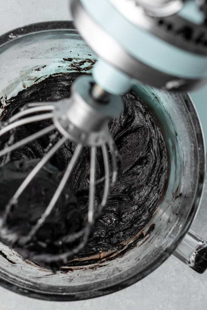 Black buttercream in a stand mixer.