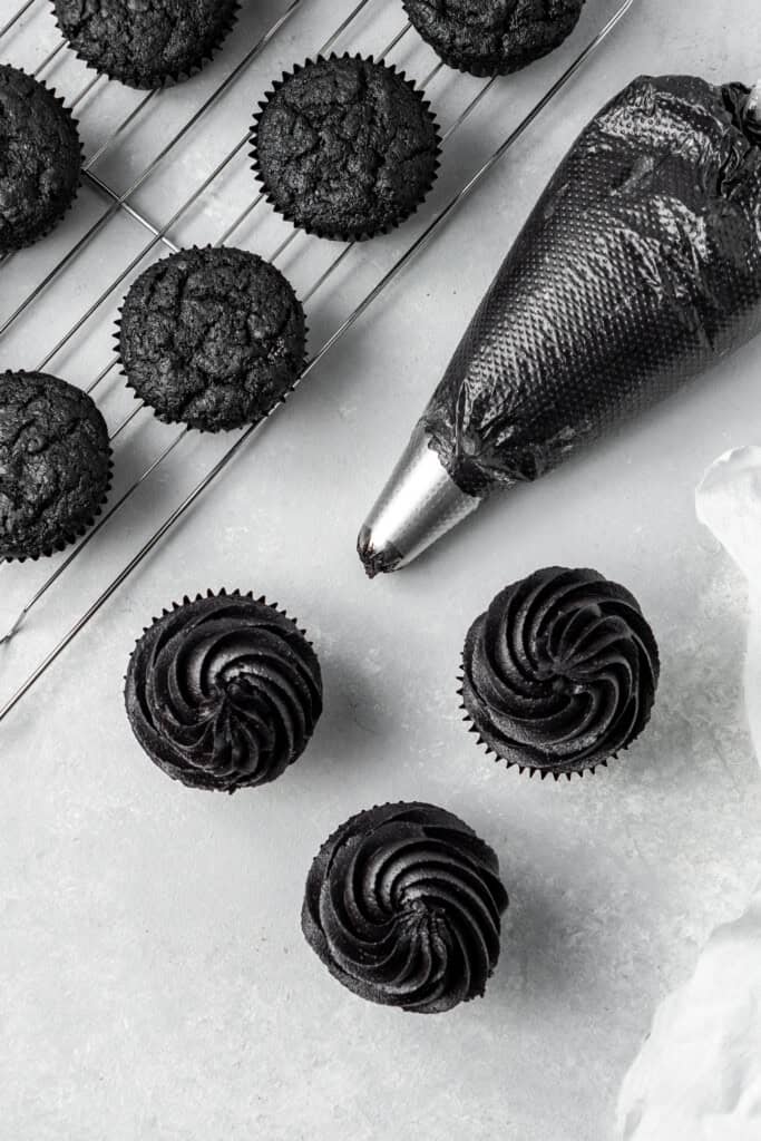 Black cocoa buttercream swirled on top of black cupcakes.