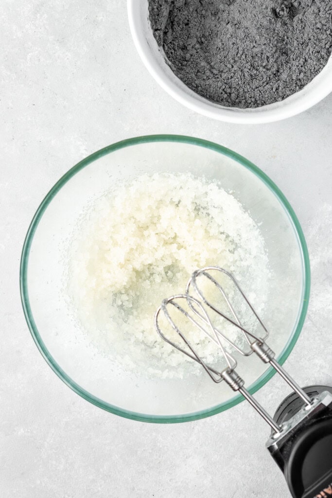 Mixing together the wet ingredients in a mixing bowl.