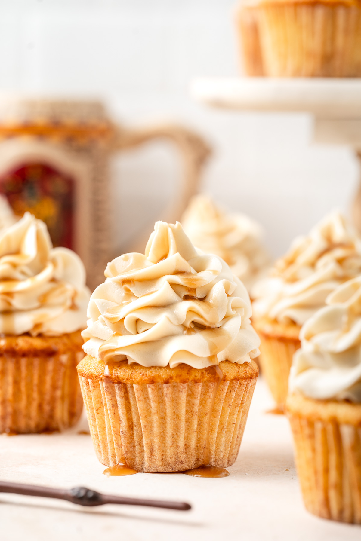 Close up of butterbeer cupcakes with butterscotch frosting and extra butterscotch drizzle.