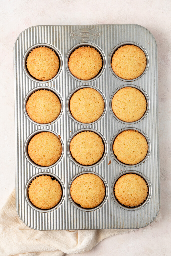 Cooked butterbeer cupcakes in a muffin pan.