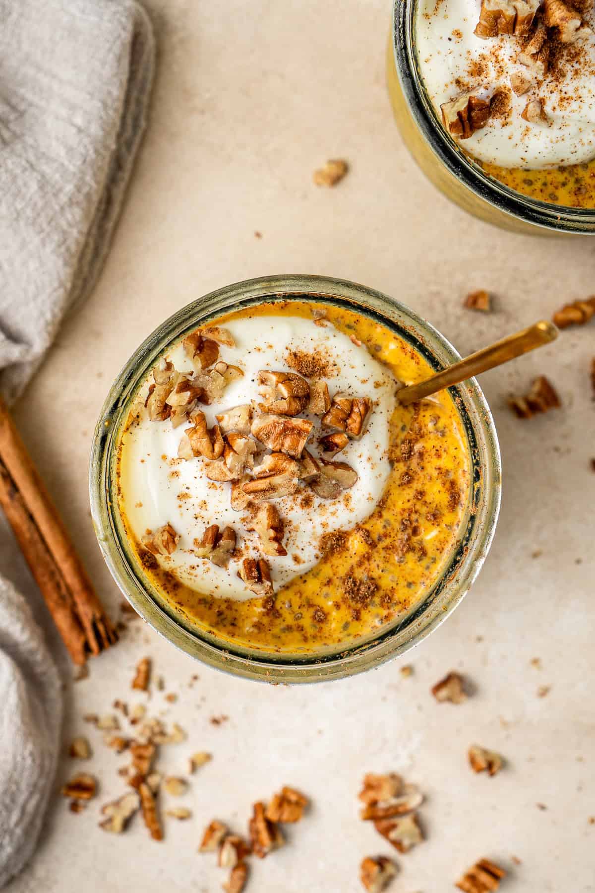 Overhead of pumpkin overnight oats with yoghurt and pecans. 