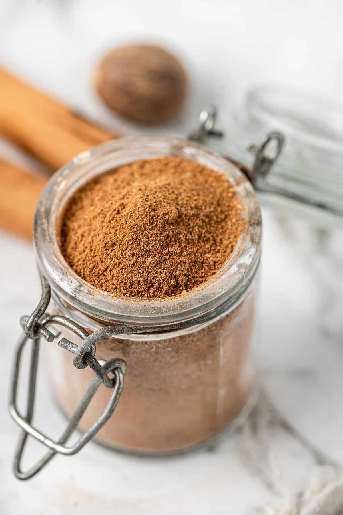 Close up of pumpkin pie spice mix in a small jar.