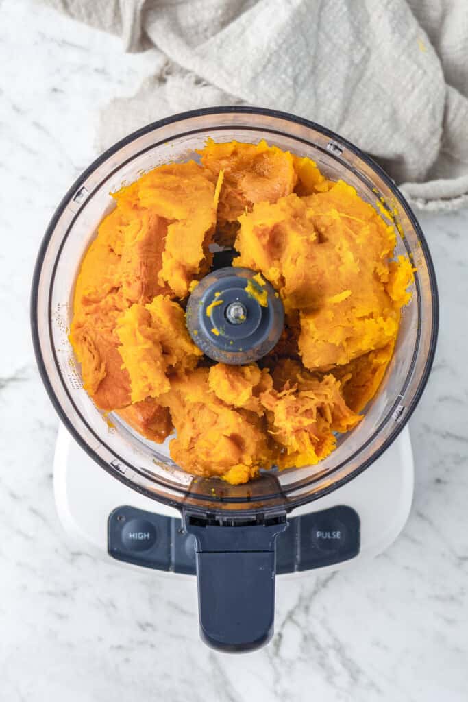 Cooked pumpkin in a food processor.