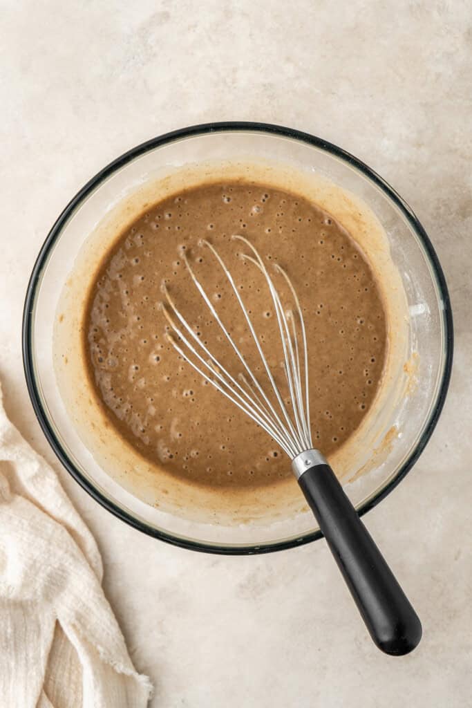 Whisking together the cake batter in a glass mixing bowl.