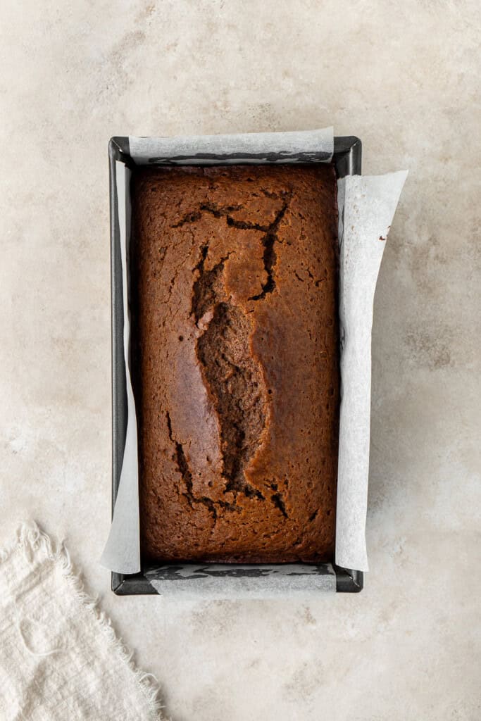 Vegan gingerbread loaf cake in a cake tin.