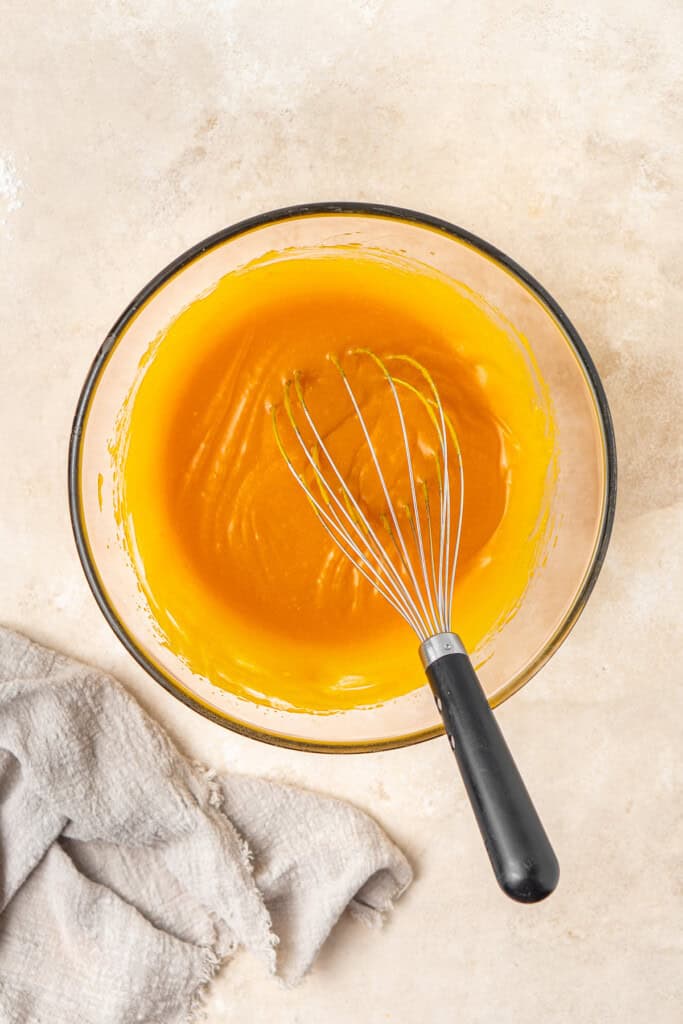 Whisking the wet ingredients in a bowl.