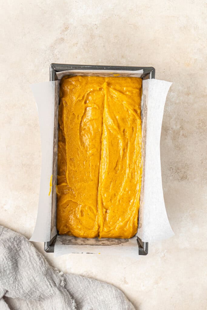 Pumpkin bread batter in a loaf pan ready for the oven.