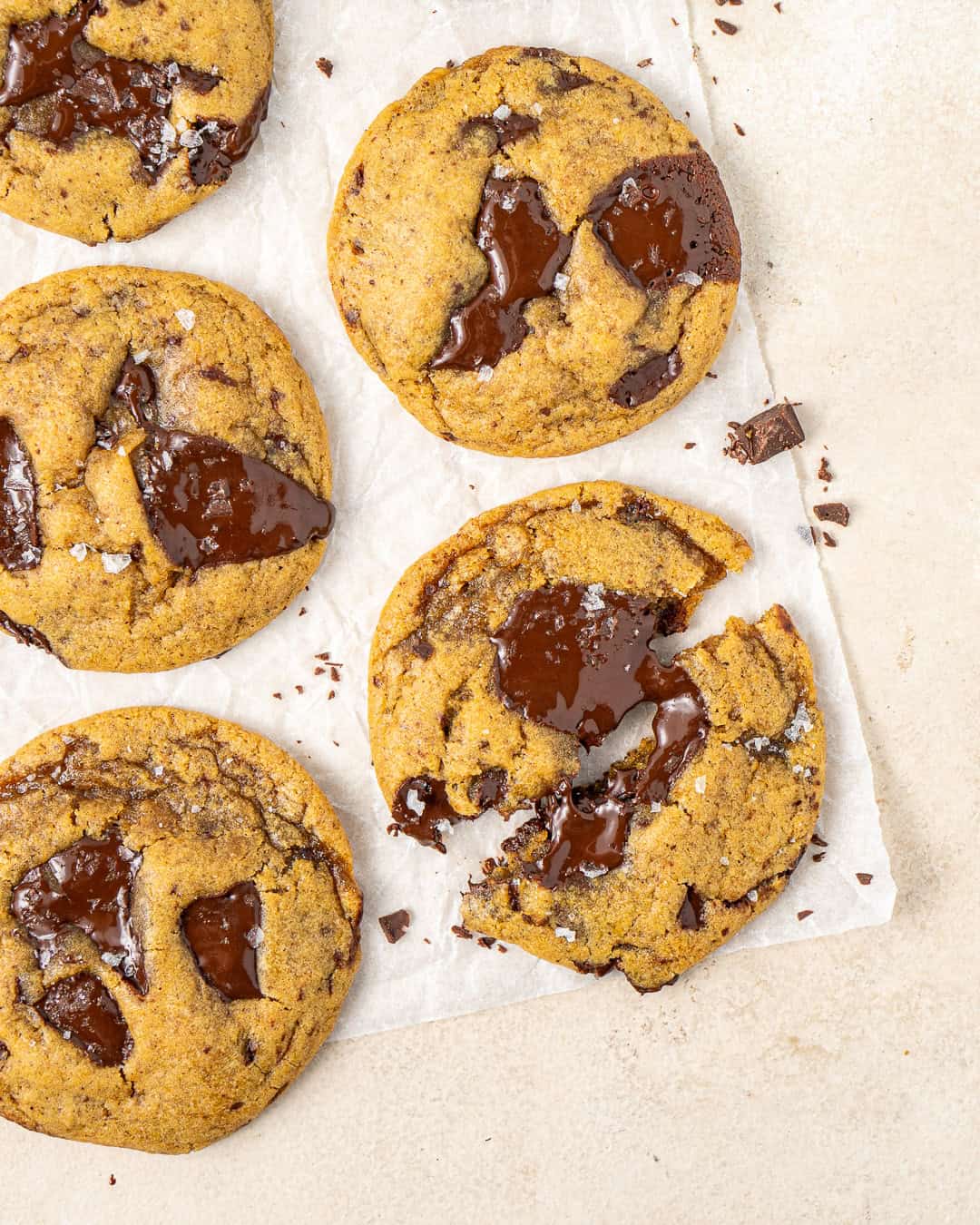 Pumpkin chocolate chip cookies with one broken in half.