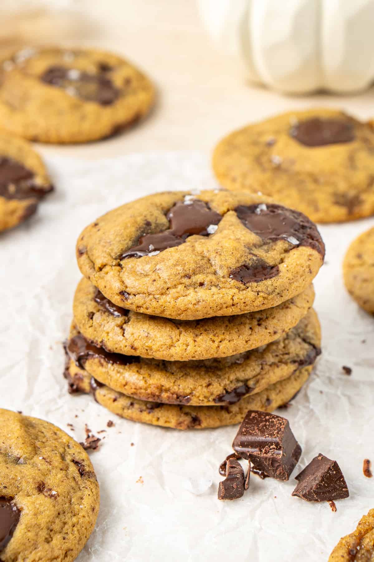 Four pumpkin choc chip cookies in a stack.