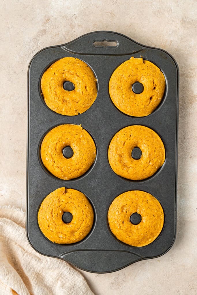 The baked pumpkin doughnuts still in the pan.