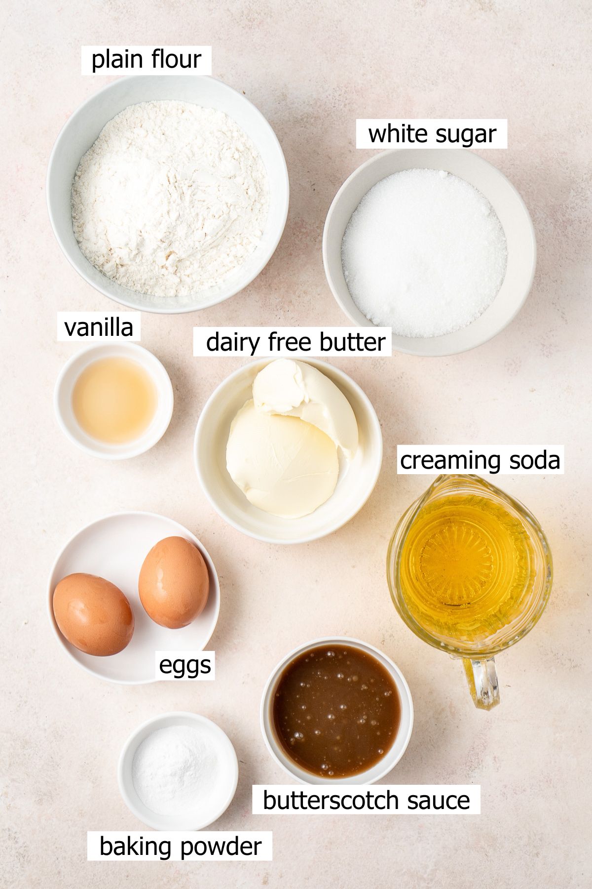 All the ingredients needed for butterbeer cupcakes laid out in small bowls.