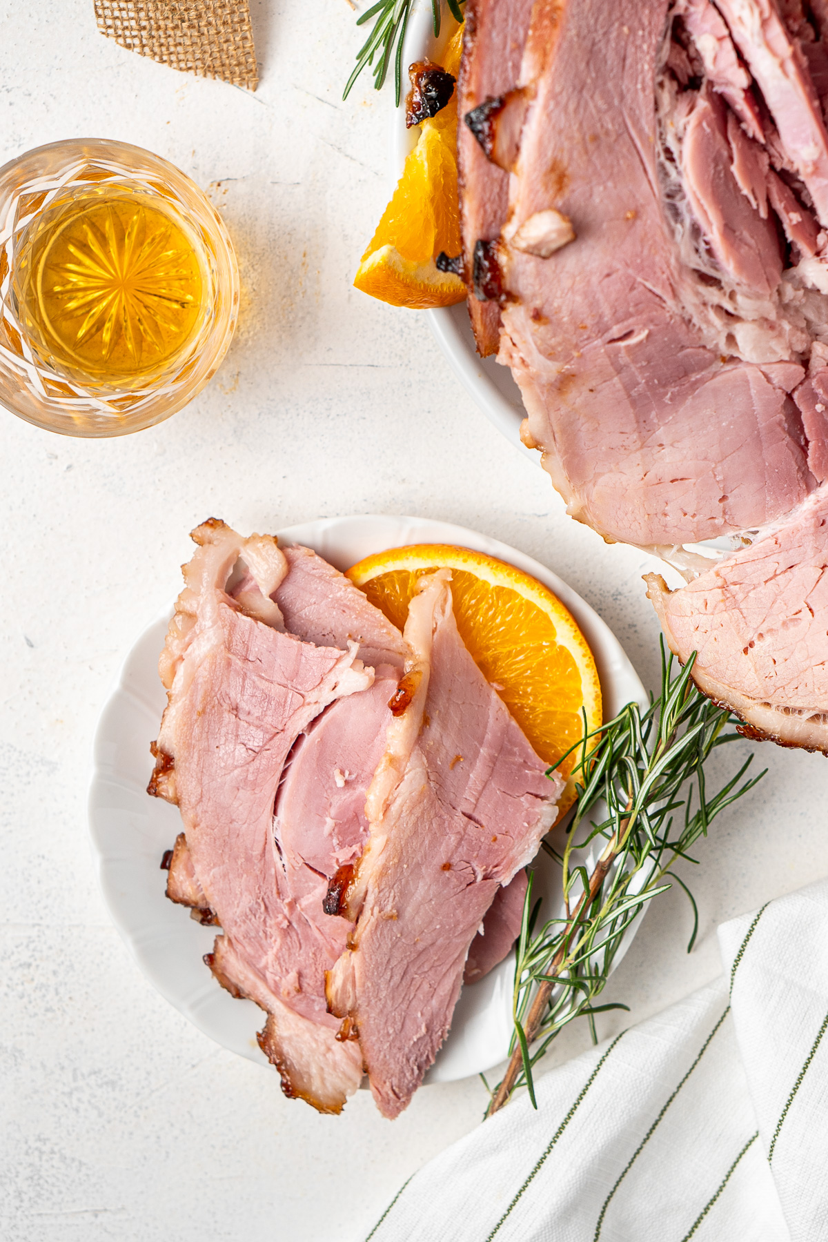 Sliced of Bourbon Brown Sugar Glazed Ham on a plate.