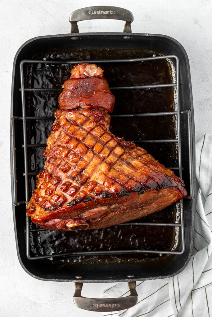 The glazed ham after cooking in a baking tray.