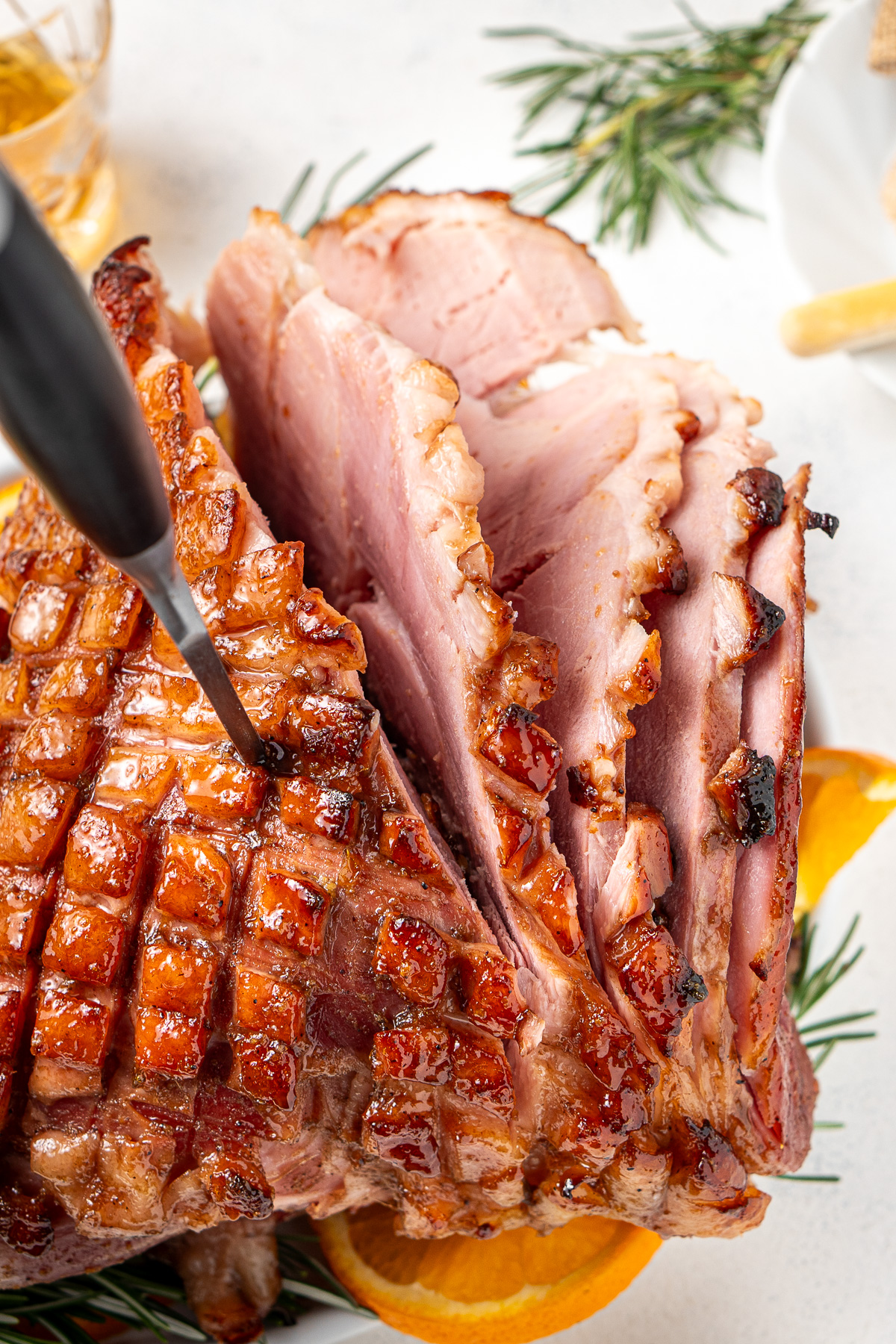 Carving a glazed ham.