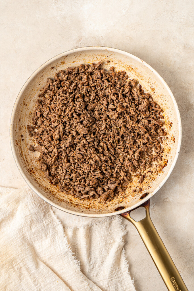 Beef mince cooked in a large frying pan.