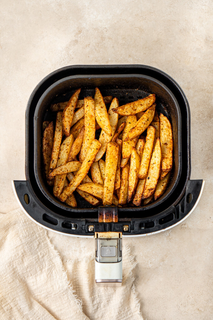 Crispy potato chips in the air fryer basket.