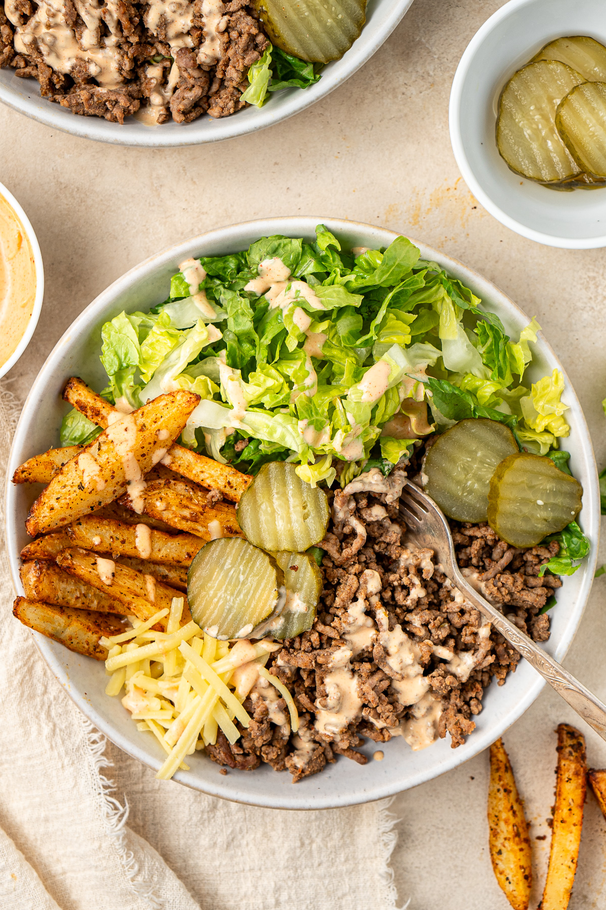 Close up of a healthy beef burger bowl with a fork taking a bite.