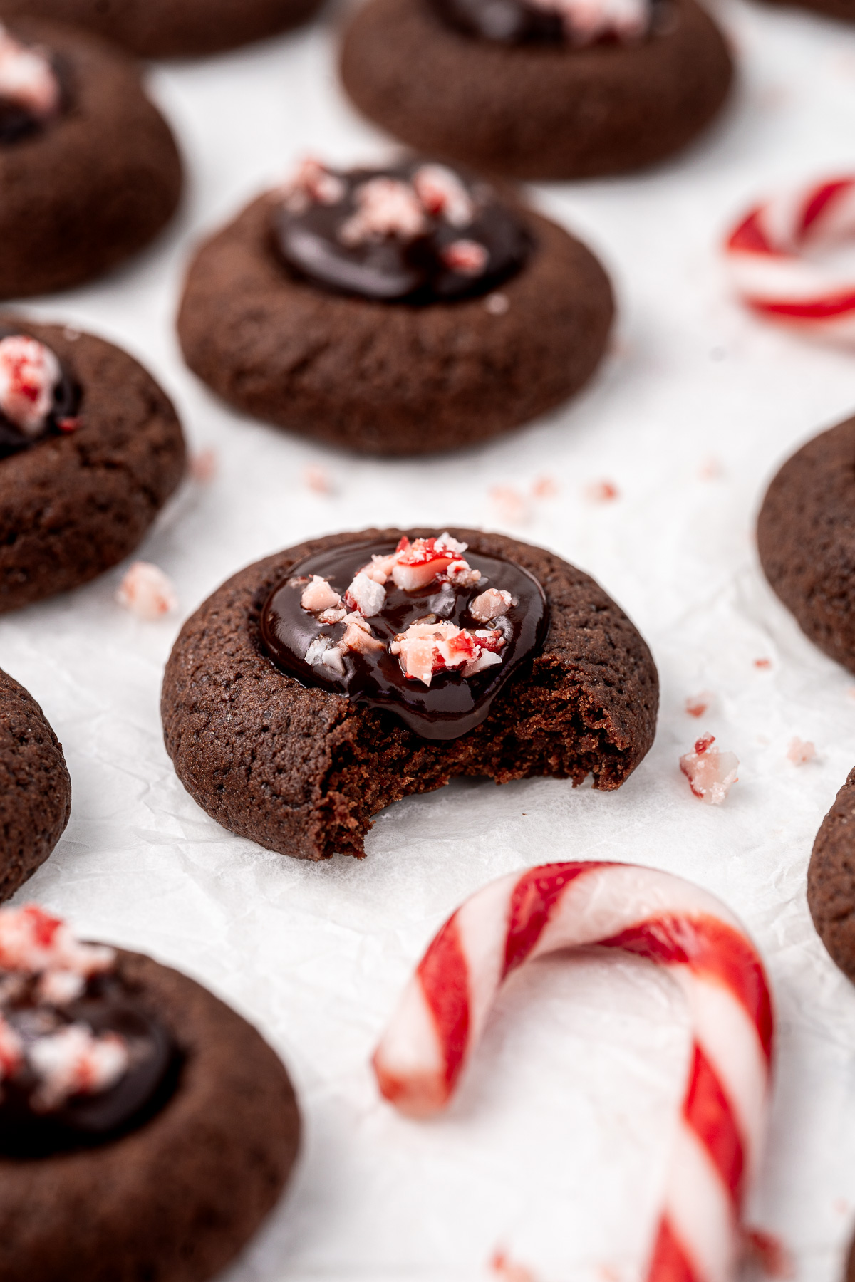 Chocolate peppermint thumbprint cookie with a bite taken.