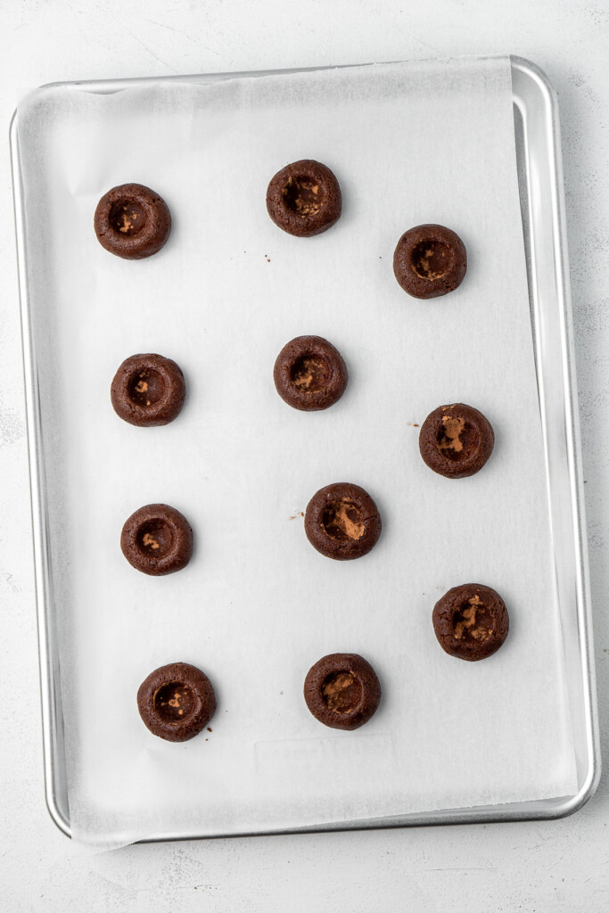 The chocolate cookies ready for baking on a tray.