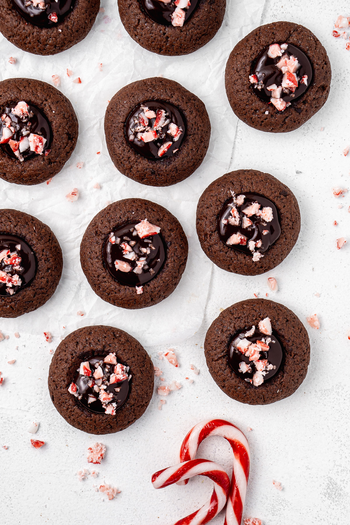 Lots of chocolate peppermint cookies with ganache and candy canes.