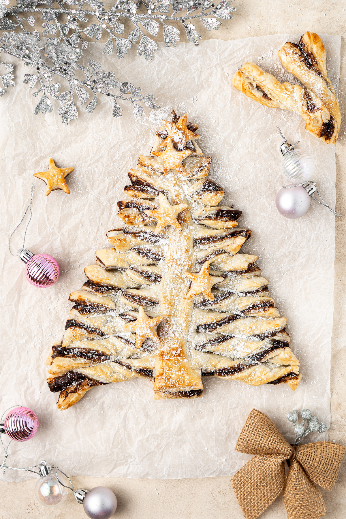 Chocolate puff pastry Christmas tree dusted with icing sugar.