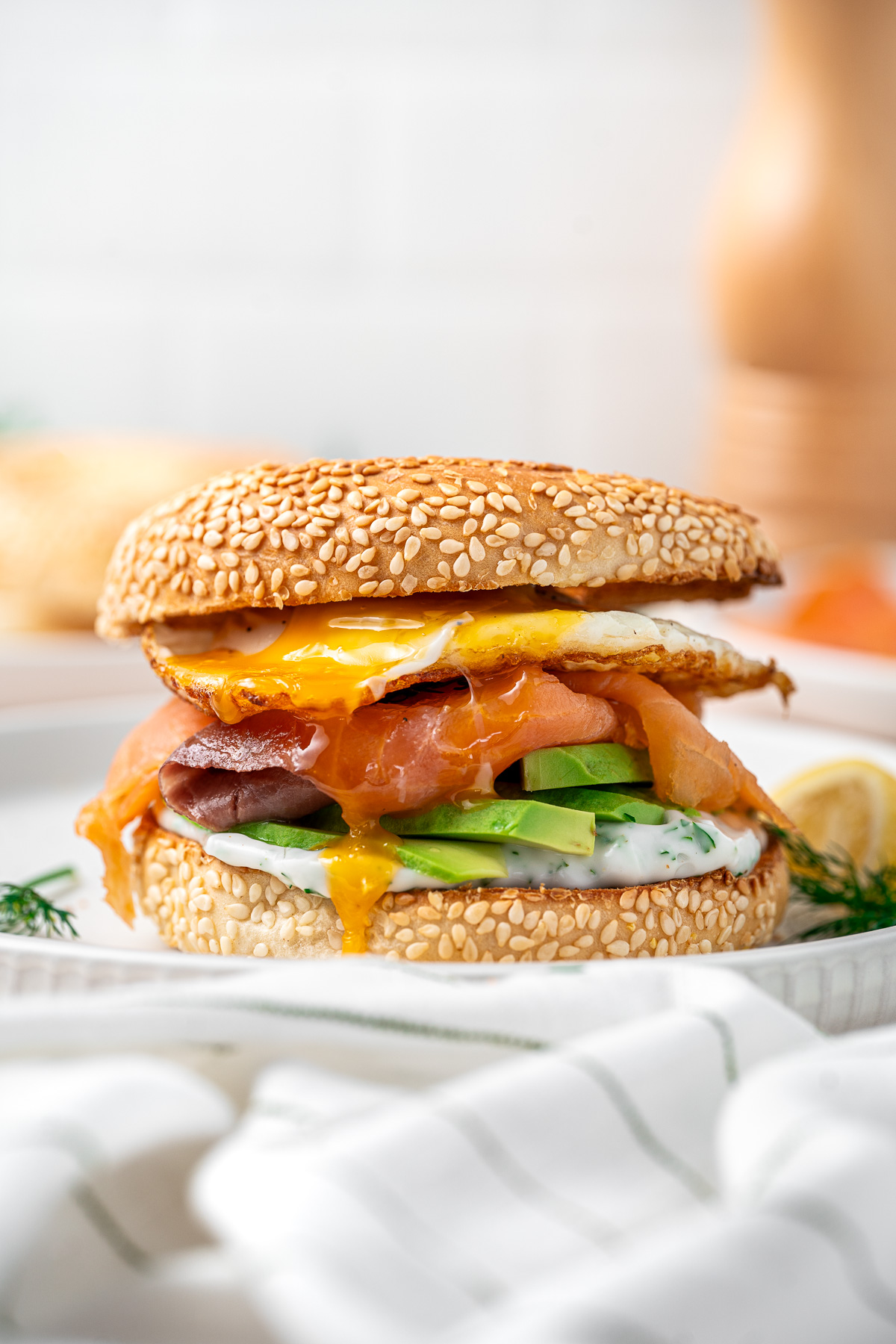 Smoked salmon and avocado bagel with runny egg. 