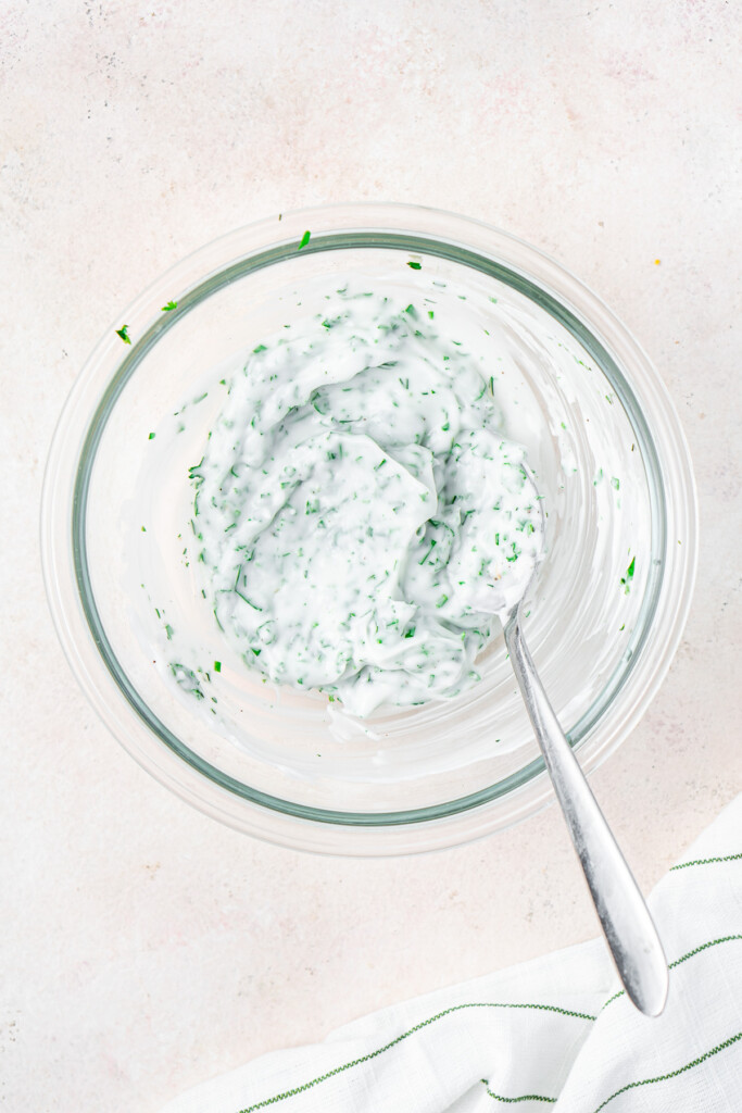 Making the herb cream cheese in a bowl.