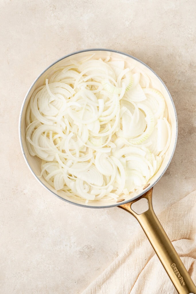 Sliced onions in a frying pan.