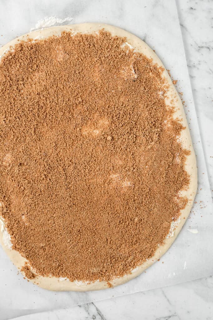 The dough rolled out and coated with cinnamon sugar.