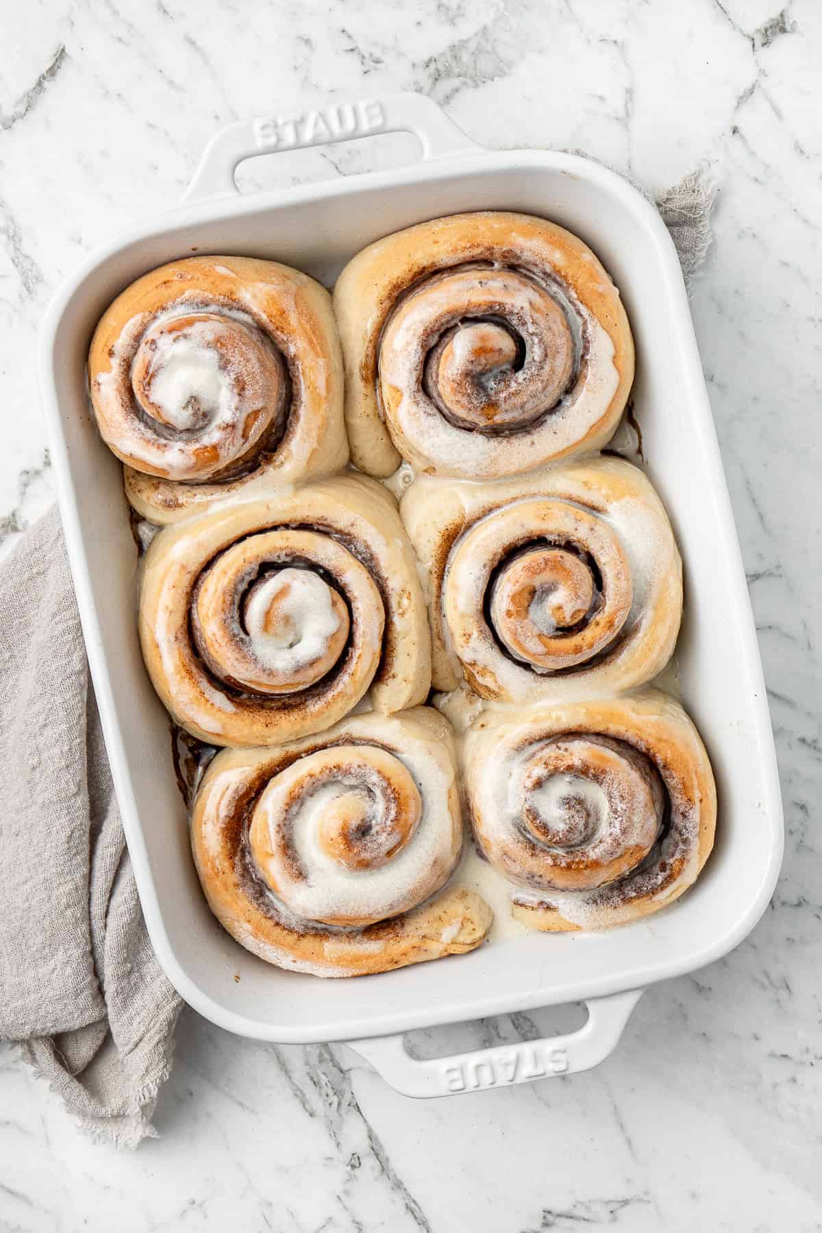 Vegan cinnamon rolls in a baking dish.