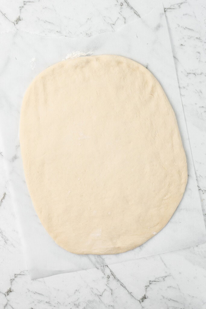 Rolling out the dough into a rectangular shape.