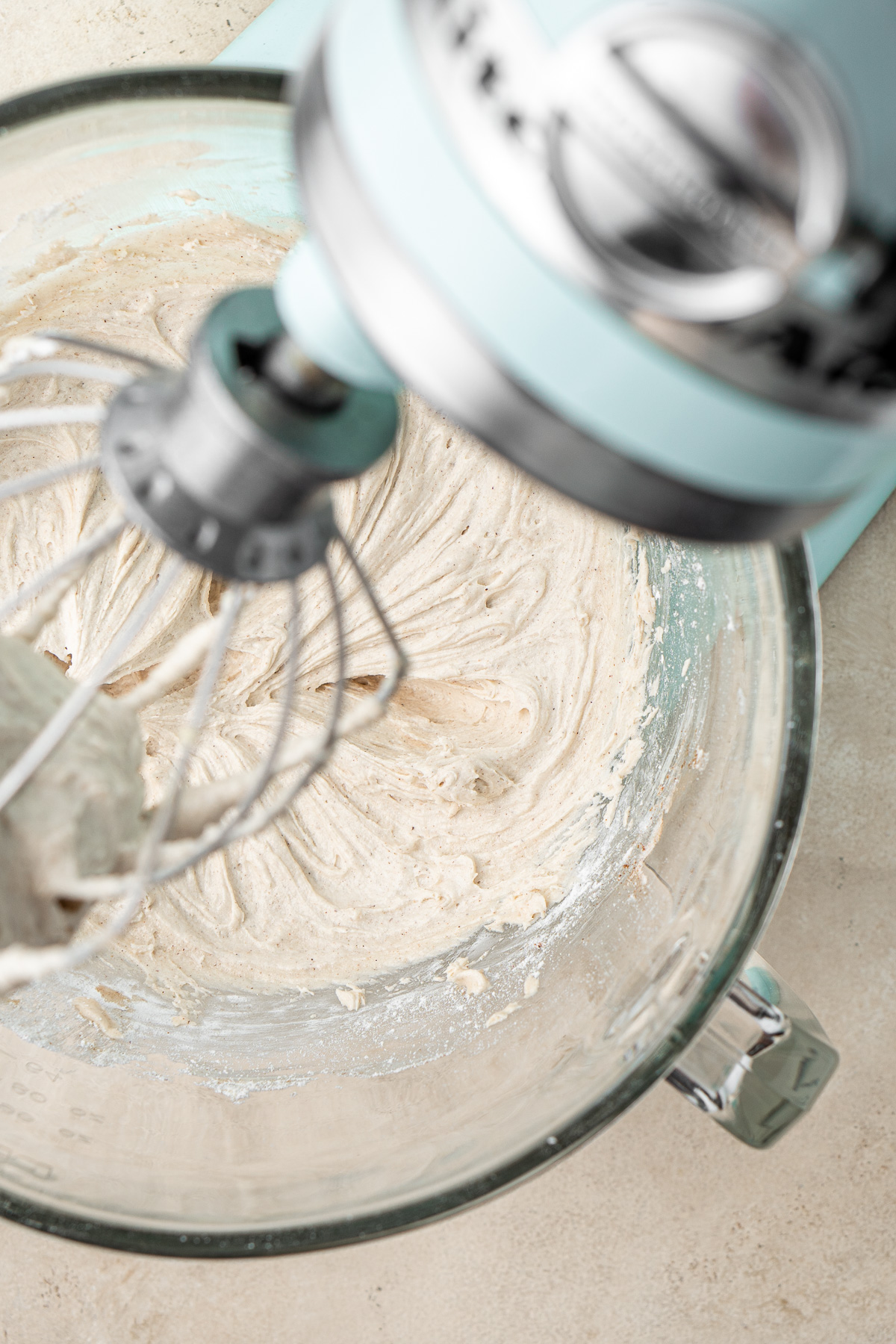 Beating together creamy vegan cinnamon frosting in a stand mixer.